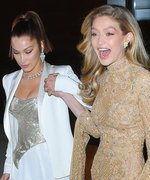 Gigi Hadid Nearly Takes a Tumble in Gold Lace Gown, Bella Catches Her Fall
